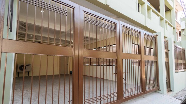 A gated entrance with a metal gate and a tiled floor. - RedDoorz Plus near Osmena Highway 2 - Quarantine Hotel (Manila)