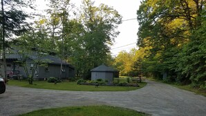 A rural setting with a house, a shed, and a grassy area. - Beach cottage on the water - private and pet friendly! (Franklin)