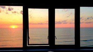 Three windows with a sunset view. - OCEANFRONT NEAR THE PIER!OCEAN VIEW FROM EVERY ROOM! 2-2 WRAPAROUND BALCONY! (Daytona Beach)
