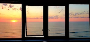 Three windows with a sunset view.