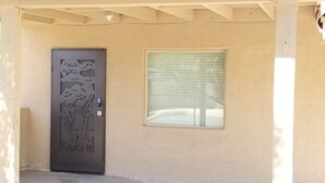 A door with a decorative panel and a window with blinds.