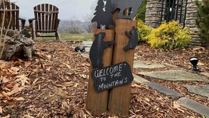 A wooden sign with a bear and a mountain, welcoming visitors to the mountains. - Don't Miss This View!!! Secluded Mountaintop Cabin- w/ Hot tub & Shuffleboard (Waynesville)