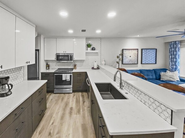 Enjoy cooking in this well-equipped kitchen with an oven, microwave, and ample workspace.