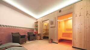A sauna room with wooden walls, a bench, and a bench with a striped cover.