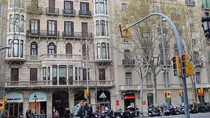 A historic building with classical architecture, featuring multiple balconies and large windows.