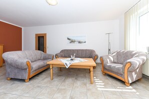 A living room with two sofas, a coffee table, and a picture on the wall.