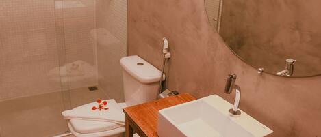 A bathroom with a shower, toilet, and sink.