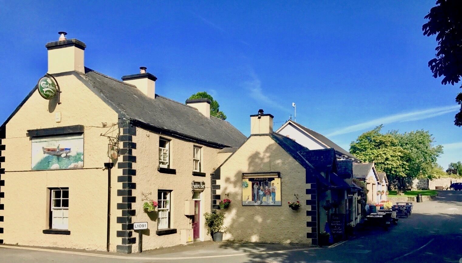 A traditional building with a sign for 'Paddy's Pub' and a visible street number 'L1091'.