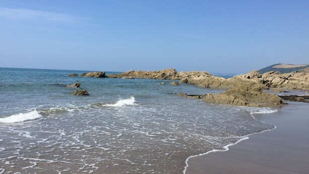 A beach with rocky formations and waves. - Luxurious home in secluded location with rural views just 5 mins drive to beach  (Torpoint)