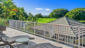 Un balcón con mobiliario exterior con vistas a un campo de golf.
