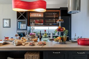 A kitchen counter with various food items and a fruit display. - PUCCINI PENTHOUSE with Terrace inside Lucca (Lucca)