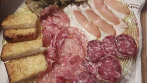 Ein Teller mit verschiedenen Fleisch- und Käsesorten.