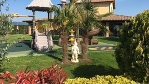 A playground with swings, slides, and a climbing structure. - Cottage  (Orciano pisano)