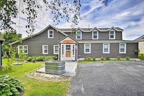 Stunning two-story home with a central entrance and beautifully manicured lawn.