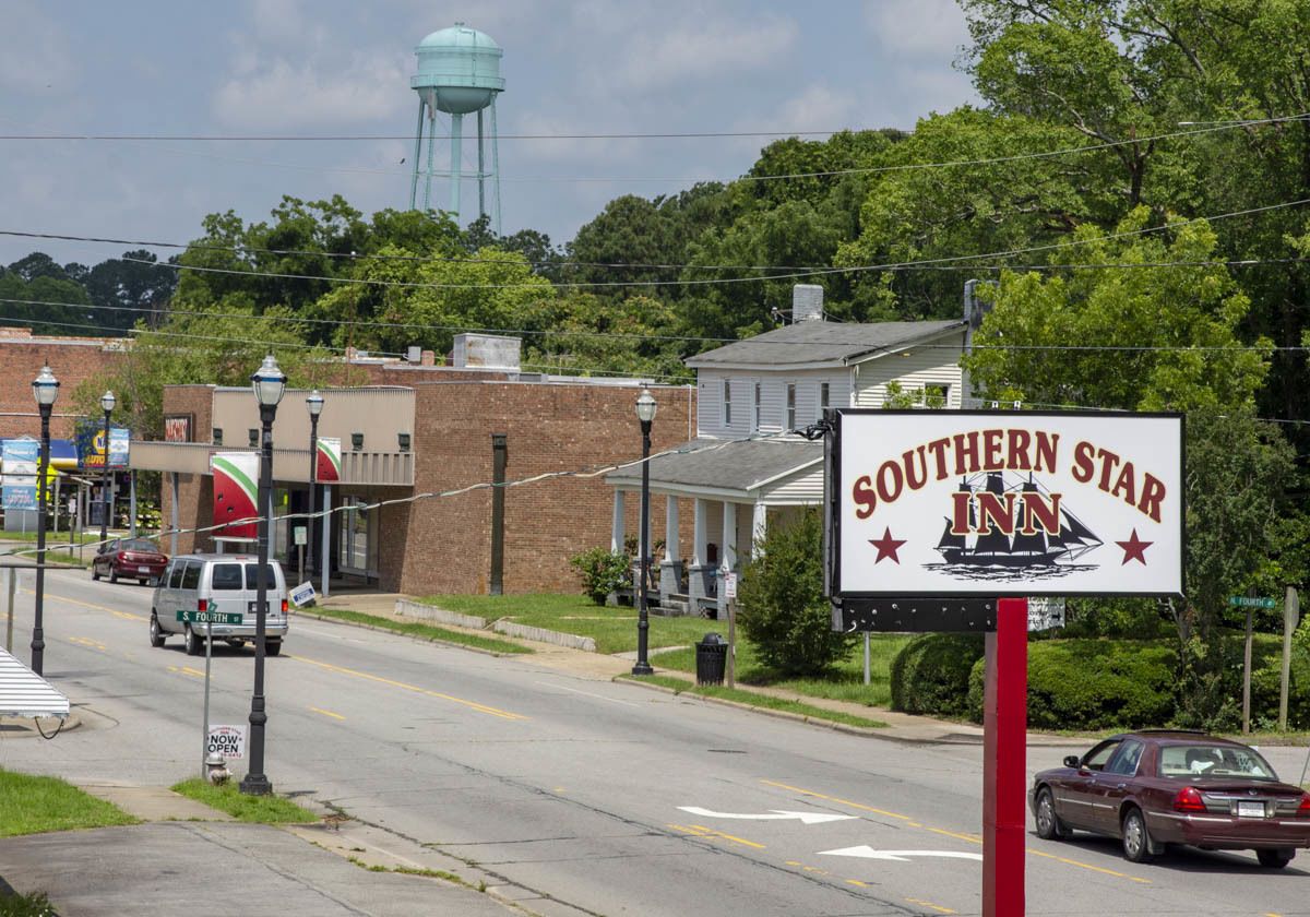 A Southern Star Inn sign with a water tower in the background.