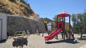 A children's play area with a slide, swings, and a climbing structure. - Il Silenzio   ground floor (Magarikari)