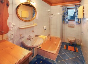 Combined shower/bathtub, hair dryer, towels, soap