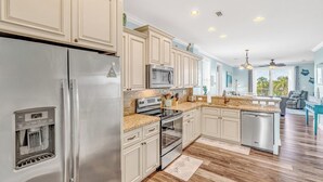 A modern kitchen with stainless steel appliances, light-colored cabinetry, and a wooden floor. - W04 - Spacious 4 bed, 3 bath home in Sombrero with private pool (Marathon)