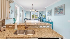 A kitchen with granite countertops, a double sink, and a dining area with a view of the outdoors. - W04 - Spacious 4 bed, 3 bath home in Sombrero with private pool (Marathon)