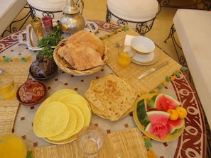Traditional Moroccan dining setup with a variety of dishes and beverages.
