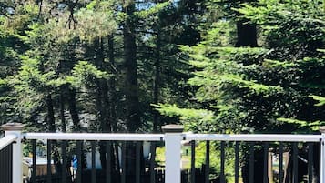 Enjoy a serene view of the surrounding forest from this elevated deck.