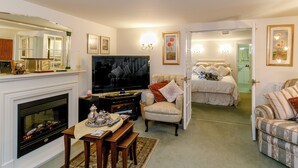 A living room with a fireplace, television, and seating area.