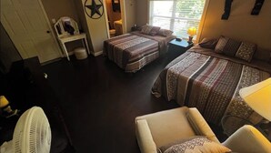 A room with two beds, a ceiling fan, a small table, and a window with blinds. - Amazing view of Lake Norfork, room for everyone! (Mountain Home)