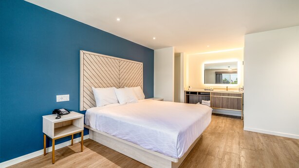 Un dormitorio moderno con cama, mesita de noche y armario empotrado.