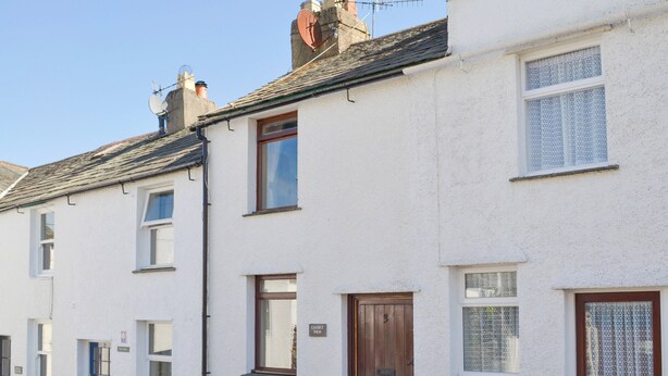 A row of white terraced houses with distinct front doors and windows. - 1 bedroom accommodation in Keswick (Keswick)