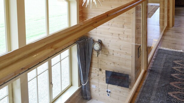 A wooden interior with a glass railing, large windows, and a decorative ceiling light. - 2 bedroom accommodation in Culbokie, near Dingwall (Culbokie, near Dingwall)