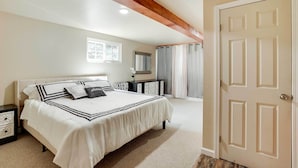 A bedroom with a bed, a nightstand, a dresser, a mirror, and a door. - Unique Castro Valley House 30 Mi to San Fran! (Castro Valley)