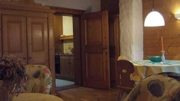 Une pièce chaleureuse, meublée de meubles en bois, avec une table à manger et une vue sur la cuisine.