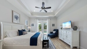 A bedroom with a bed, a bench, a dresser, a chair, and a ceiling fan. - Beautiful New Marco Island Home Minutes to Beaches, Parks & Restaurants (Marco Island)