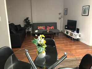 City Apartment (Apartment 3) | Living room | 50-inch LCD TV with cable channels, TV, Netflix - Clifton Hill Stays (Niagara Falls)
