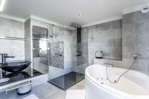 Bathtub, hair dryer, towels, toilet paper