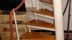 A staircase with wooden steps and a red rope barrier. - Summer house, rowing boat incl. - Summer house (Krakow am See)