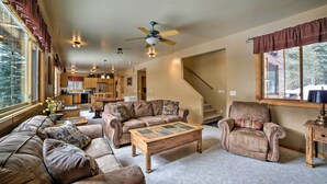 A spacious living room with leather sofas, a wooden coffee table, and a ceiling fan. - Secluded mountain retreat (Dolores)