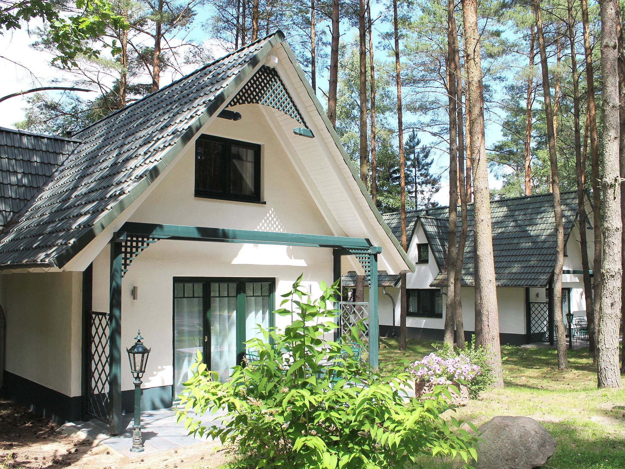 A traditional-style building with a sloped roof, a front entrance, and a small porch area.