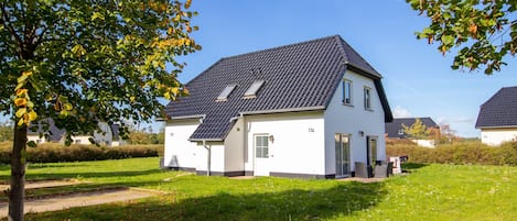A single-story house with a sloped roof, a front door, and a small porch.