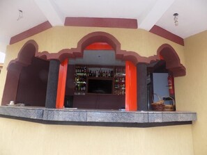 Enjoy a drink at the bar, surrounded by a unique architectural design featuring arches and a column structure.