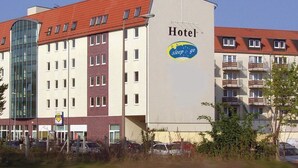 A hotel building with a sign reading "Hotel sleep & go" and a glass entrance.