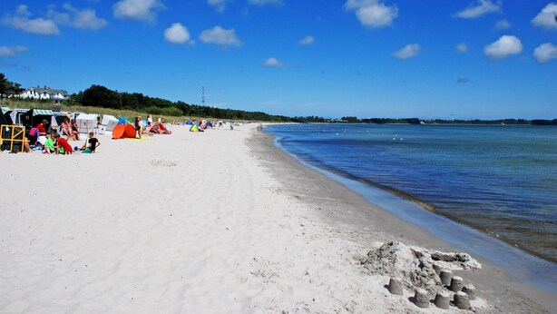 A beach with tents and people.