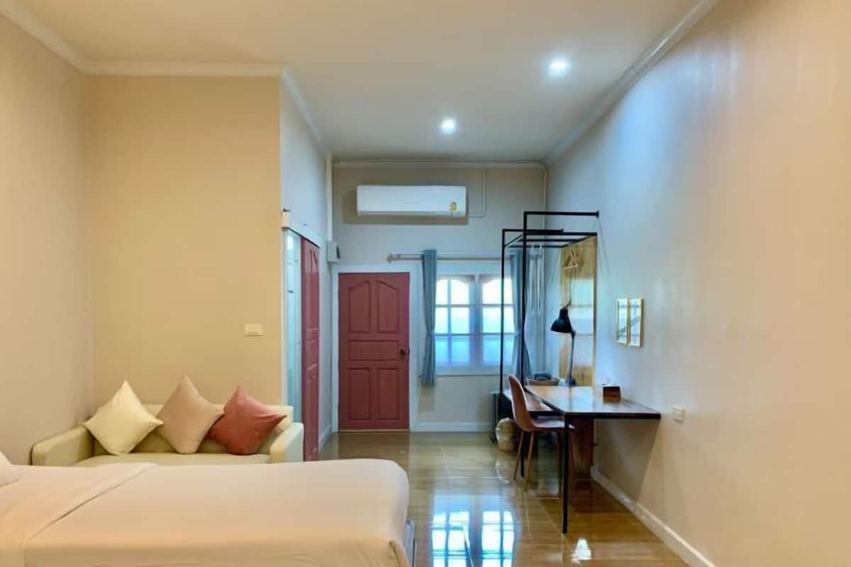 Premium bedding, desk, laptop workspace, blackout drapes
