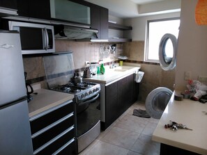 Fridge, coffee/tea maker, cookware/dishes/utensils, dining tables