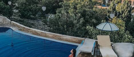 Seasonal outdoor pool, open 10:00 AM to 7:00 PM, pool umbrellas