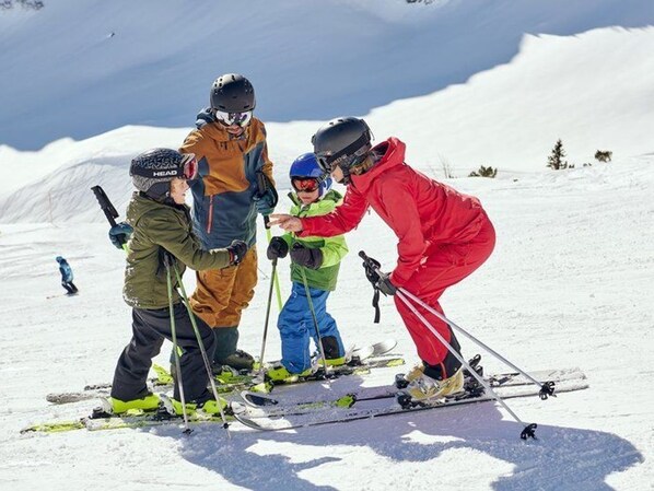 A group of people on skis on a snowy slope.