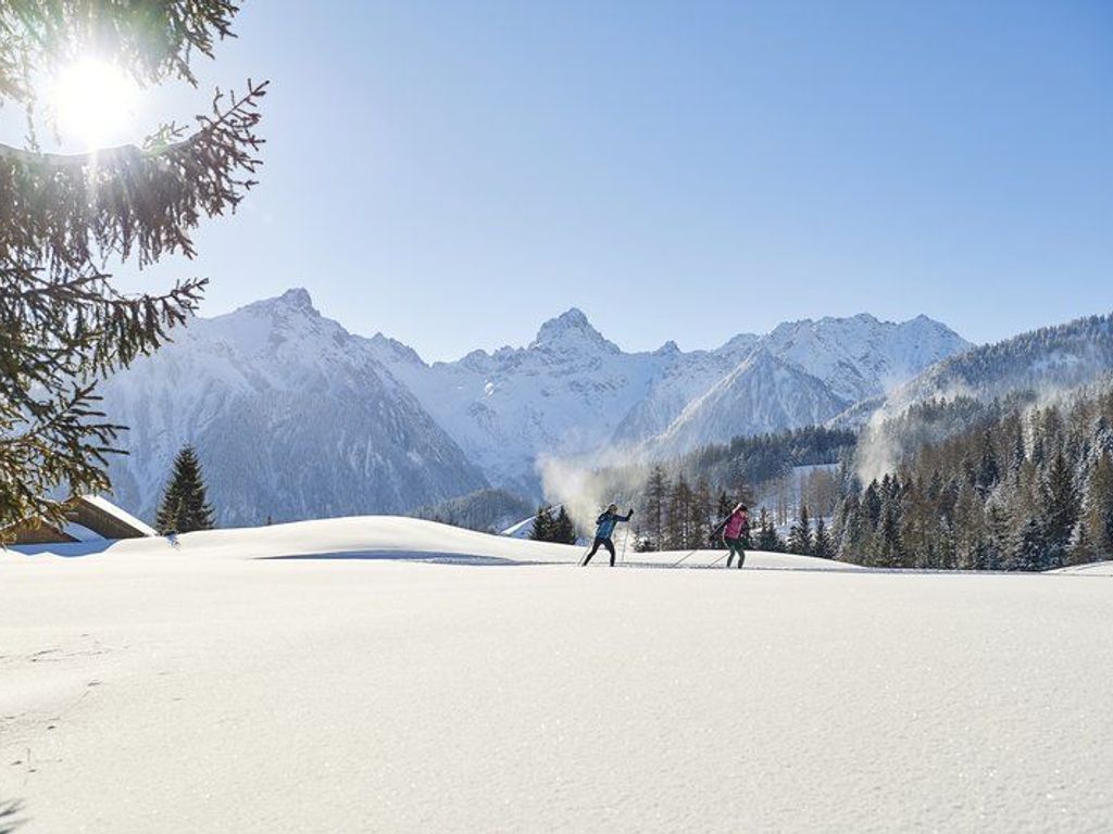 Un paysage enneigé avec une chaîne de montagnes en arrière-plan.