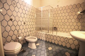Bathtub, hair dryer, towels, soap