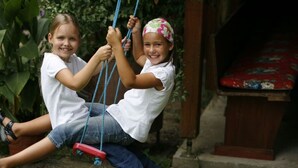 Two children on a swing set outdoors. - An oasis for parents, a paradise for children (Tettnang)