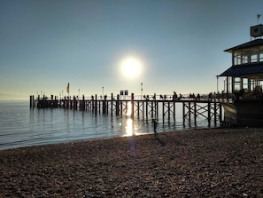 A pier extending into calm waters with a clear sky. - An oasis for parents, a paradise for children (Tettnang)